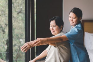 Physiotherapist training with elderly woman patient at home,Physical therapy concept